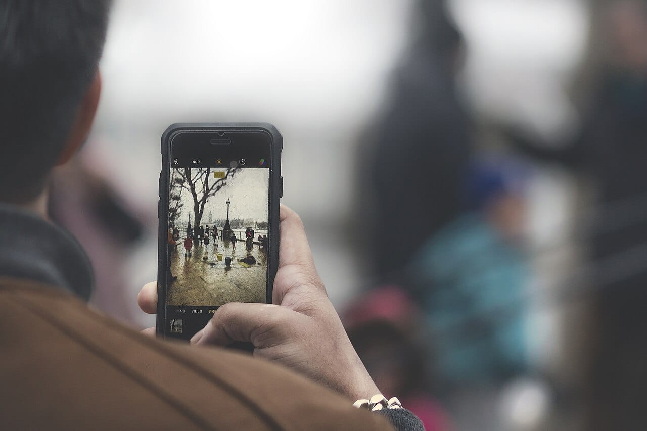 Someone taking a photo with a smartphone, the entry point for a library that used to be unlimited to store. Photo: James Sutton, Wikimedia Commons, CC0 (Public Domain).