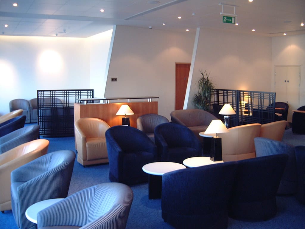 Empty armchairs and lamps in an airline business class lounge