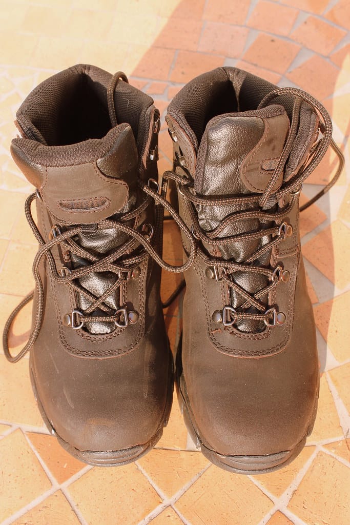 A pair of worn leather hiking boots