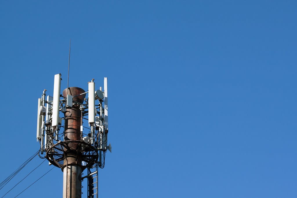 A cell phone tower against a clear blue sky