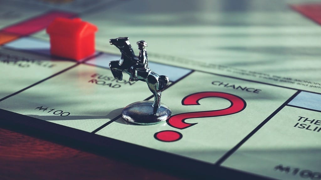 A Monopoly board game token on the Chance square