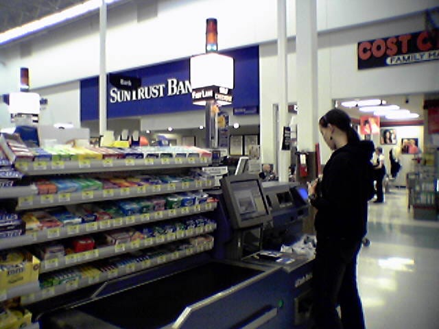A shopper using a self-checkout kiosk