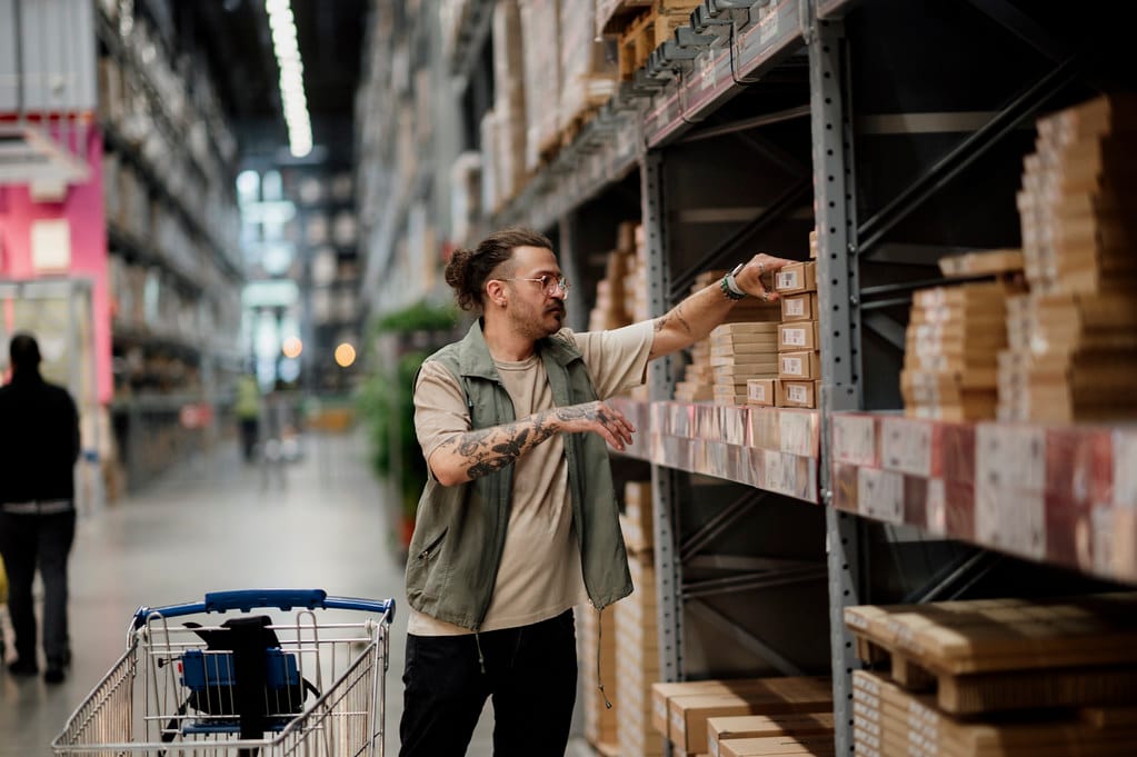 A shopper browsing shelves in a warehouse-style retail store