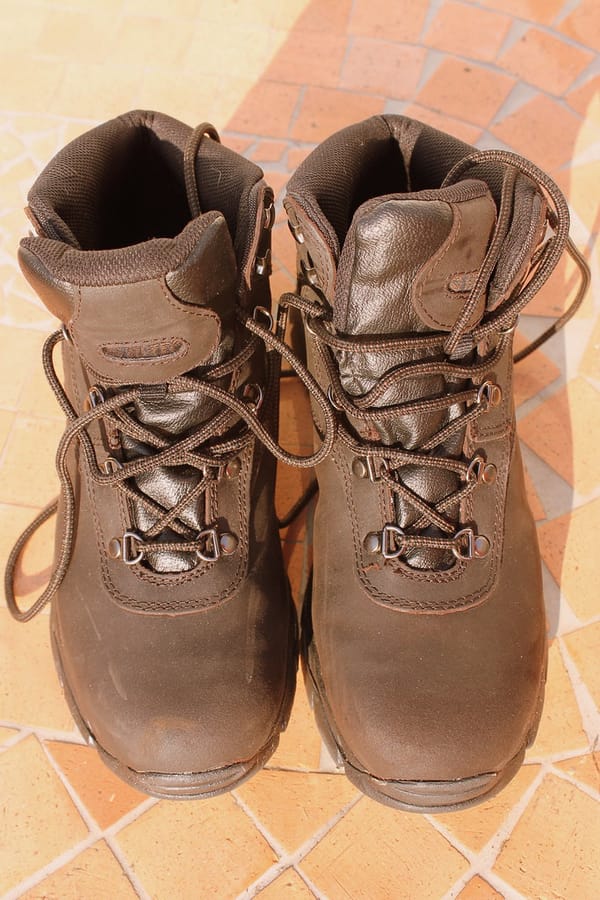 A pair of worn leather hiking boots