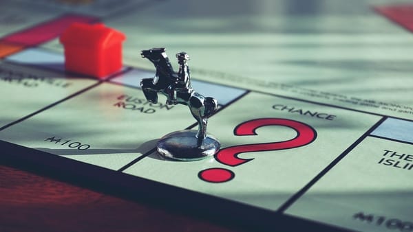 A Monopoly board game token on the Chance square