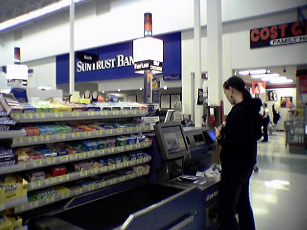 A shopper using a self-checkout kiosk